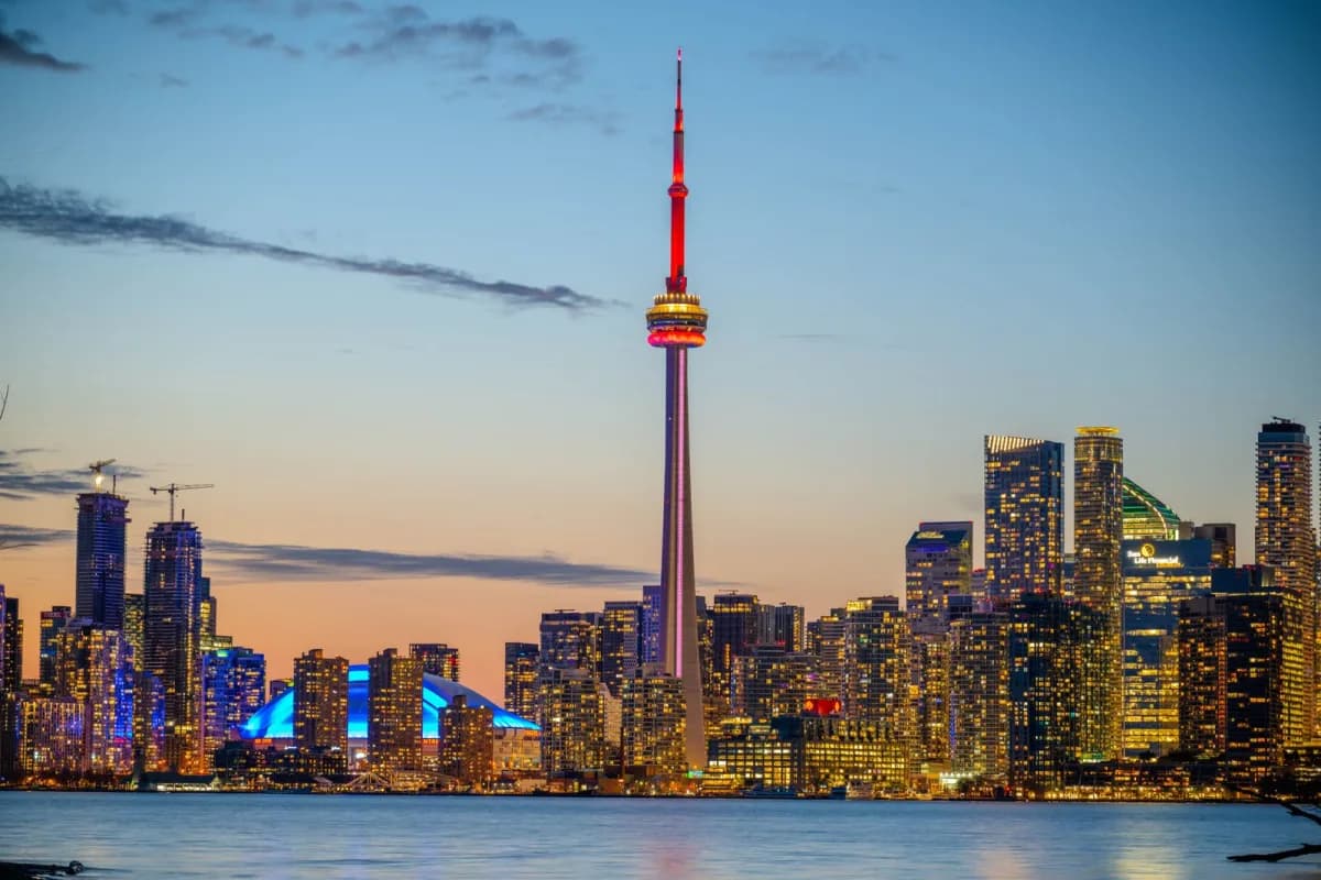 Illustration of a Toronto skyline with interest rate chart overlays at dusk