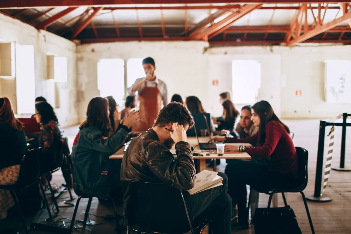 University students studying together in a classroom group discussion