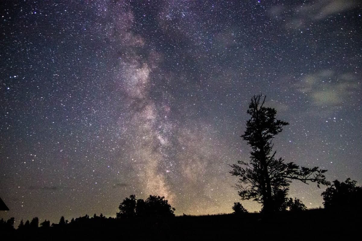 The Milky Way arching over a dark Canadian landscape at night