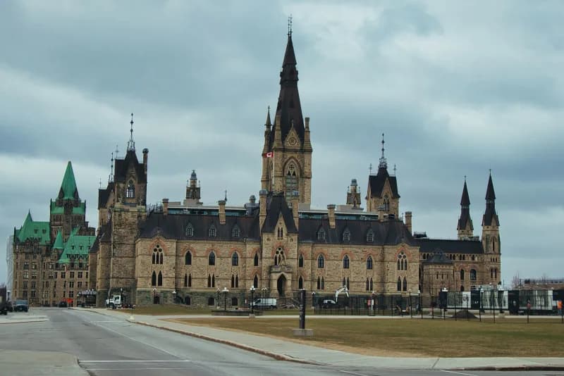 Parliament Hill in Ottawa with digital circuit overlays representing Canada's AI strategy