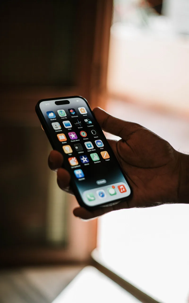 Person holding a modern smartphone showing its display