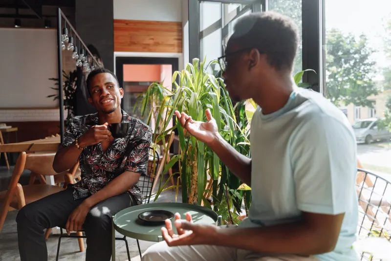 Two friends having an honest conversation over coffee